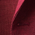 Macro detail of deep red basketweave fabric texture showing the intricate weave pattern and wool fiber quality