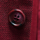 Close-up of dark red horn buttons on deep red basketweave sport coat jacket showing natural marble-like patterns
