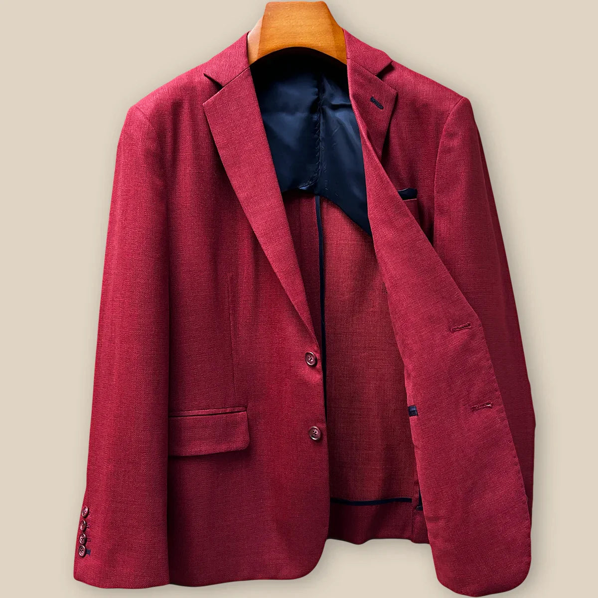 Interior left side of deep red basketweave sport coat jacket displaying navy blue lining with inner pocket