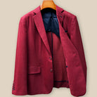 Interior left side of deep red basketweave sport coat jacket displaying navy blue lining with inner pocket