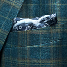 Breast pocket of deep teal green multi check suit jacket with built-in pocket square holder and hand-finished edges