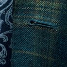 Detailed macro shot of hand-finished buttonhole stitching on deep teal green multi check suit with olive green contrast thread