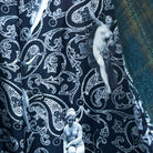 Colorful flash lining detail visible at jacket cuffs and vents in black and white paisley with figure print pattern