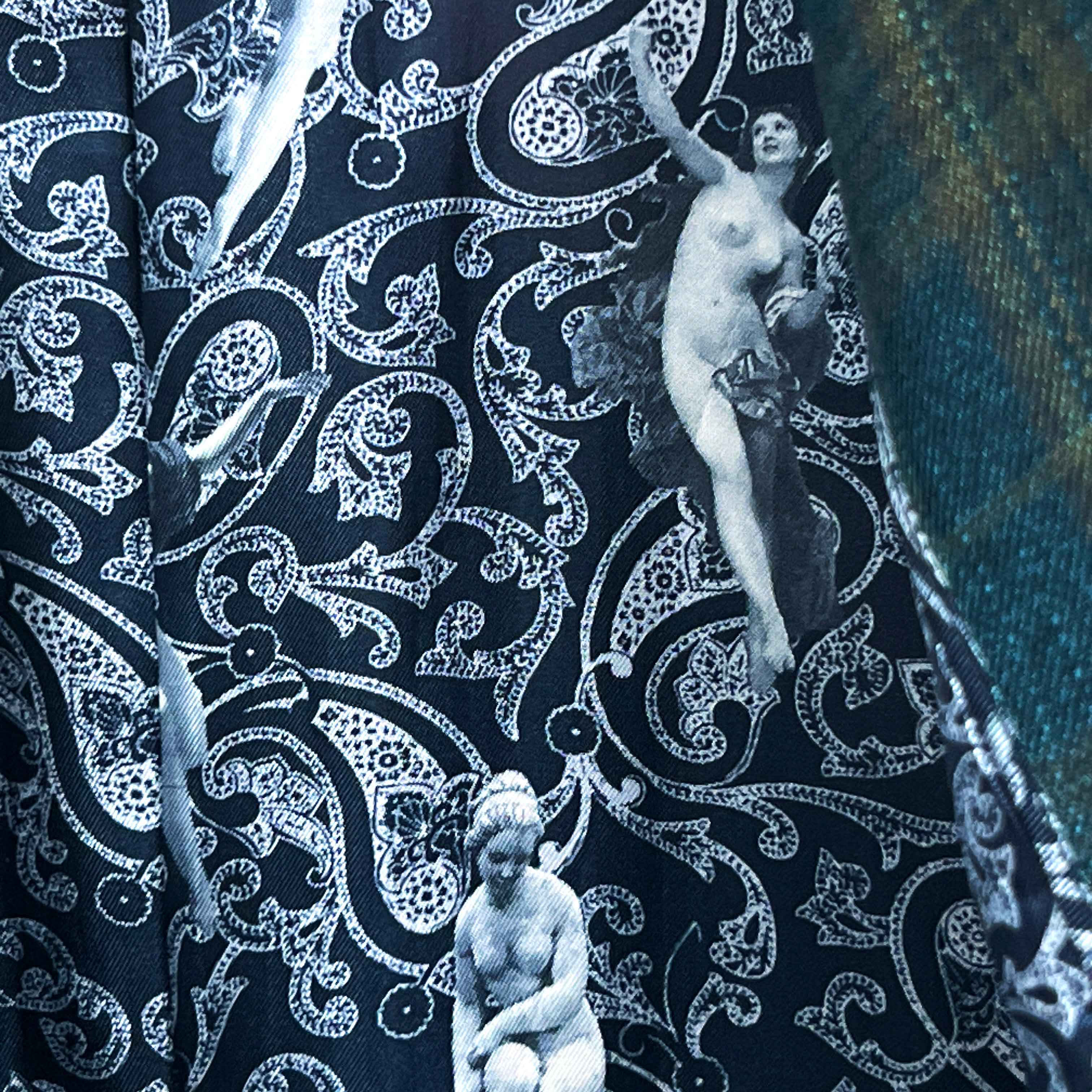 Colorful flash lining detail visible at jacket cuffs and vents in black and white paisley with figure print pattern