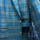 Complete two-piece deep teal green multi check custom suit displayed on hanger showing jacket and trousers with plaid check pattern