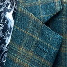 Classic notch lapel detail on deep teal green multi check suit jacket showing hand pick stitching and plaid check pattern
