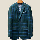 Close-up view of forest green windowpane sport coat showing contrast bright blue accent buttonhole with hand-finished stitching detail