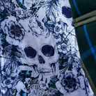 Colorful flash lining detail visible at jacket cuffs and vents in white and light blue floral and skull pattern
