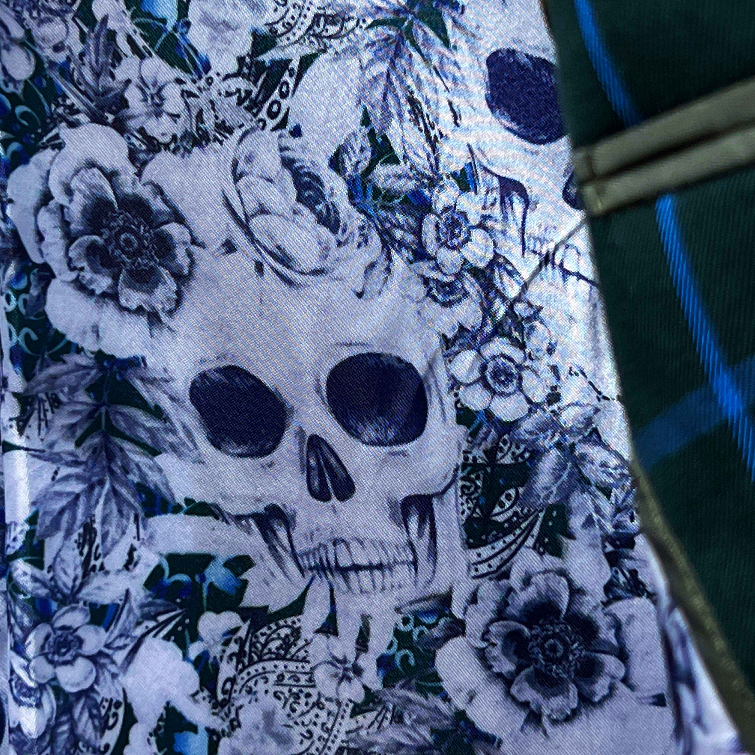 Colorful flash lining detail visible at jacket cuffs and vents in white and light blue floral and skull pattern