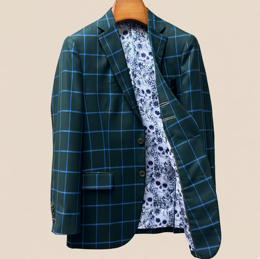 Interior left side of forest green windowpane sport coat displaying white and light blue floral and skull pattern lining with inner pocket