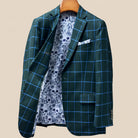 Interior right side of forest green windowpane sport coat revealing floral and skull pattern lining and internal construction details