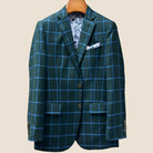 Front button panel of forest green windowpane sport coat featuring green tortoise shell buttons and hand pick stitching