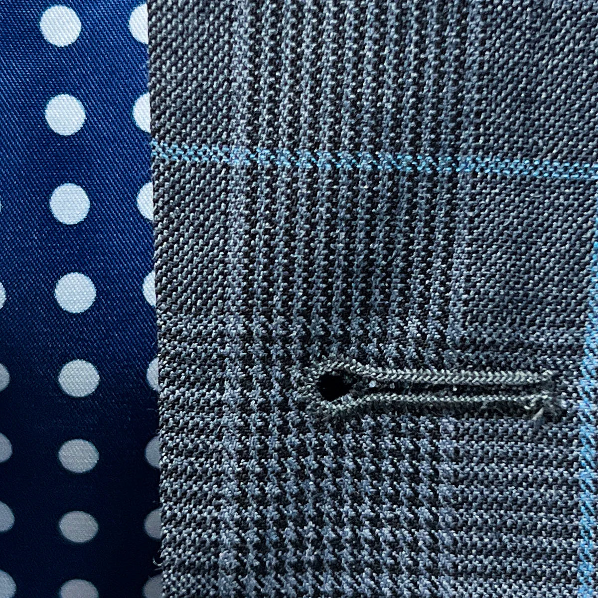 Macro shot of precision buttonhole stitching showing royal blue accent thread