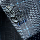 Detailed view of functional sleeve buttonholes with royal blue accent stitching