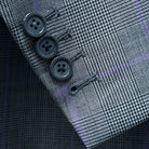 Detailed shot of suit jacket sleeve, showcasing working buttonholes and horn buttons