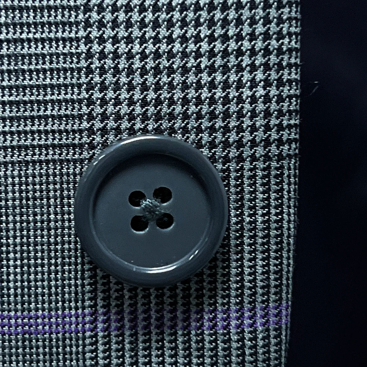 Detailed shot of grey horn buttons, showcasing their unique marble-like texture