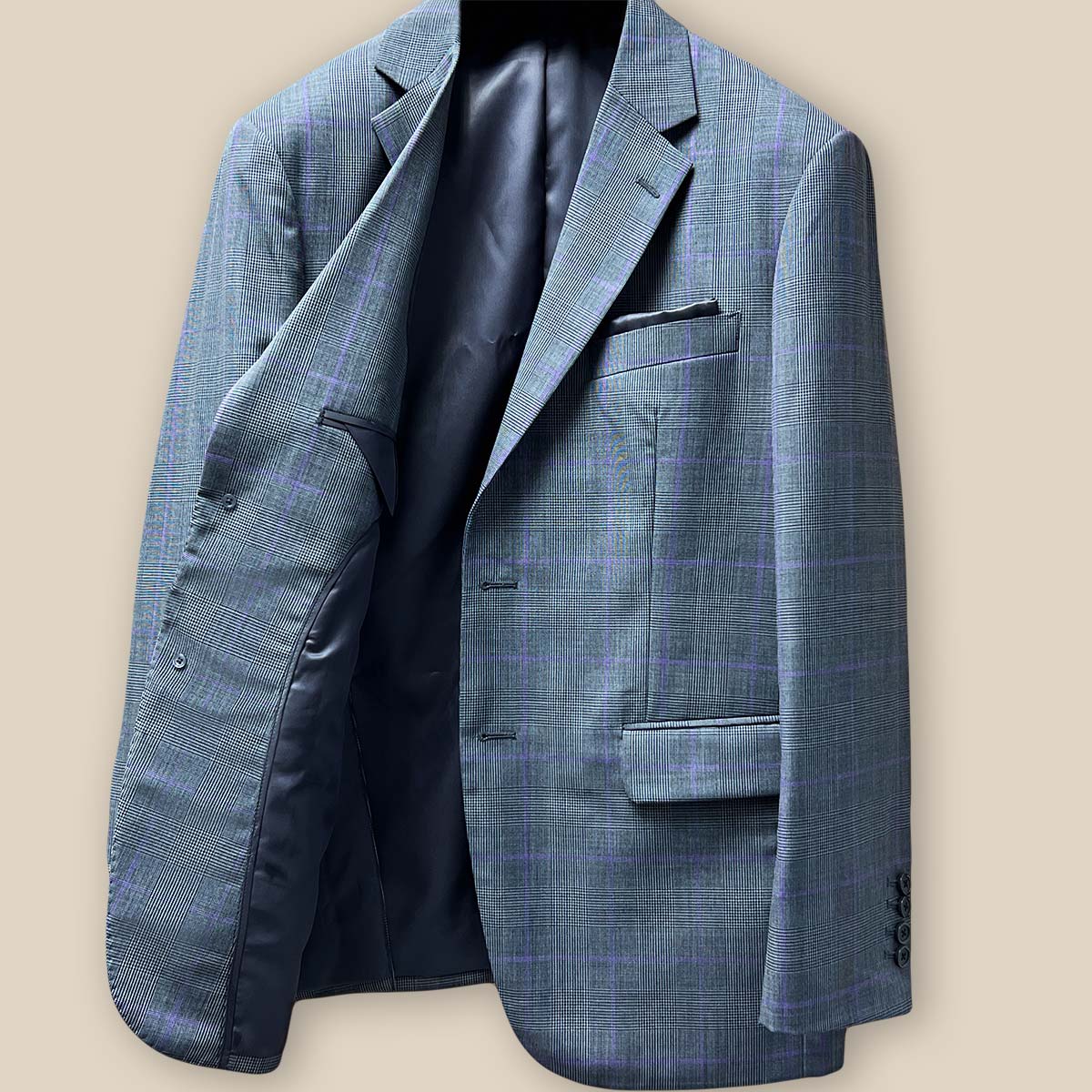 Interior view of grey suit jacket's right side, showing structural elements and lining