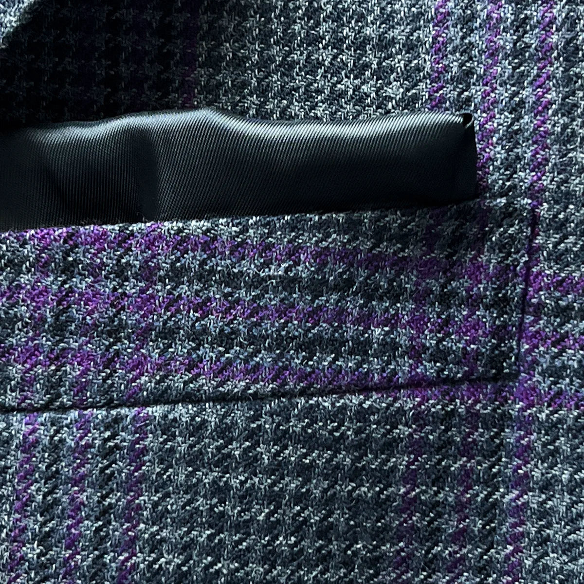 Close-up of built-in pocket square feature in grey and purple plaid fabric