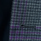 Macro view of precise buttonhole stitching on custom grey houndstooth sport coat