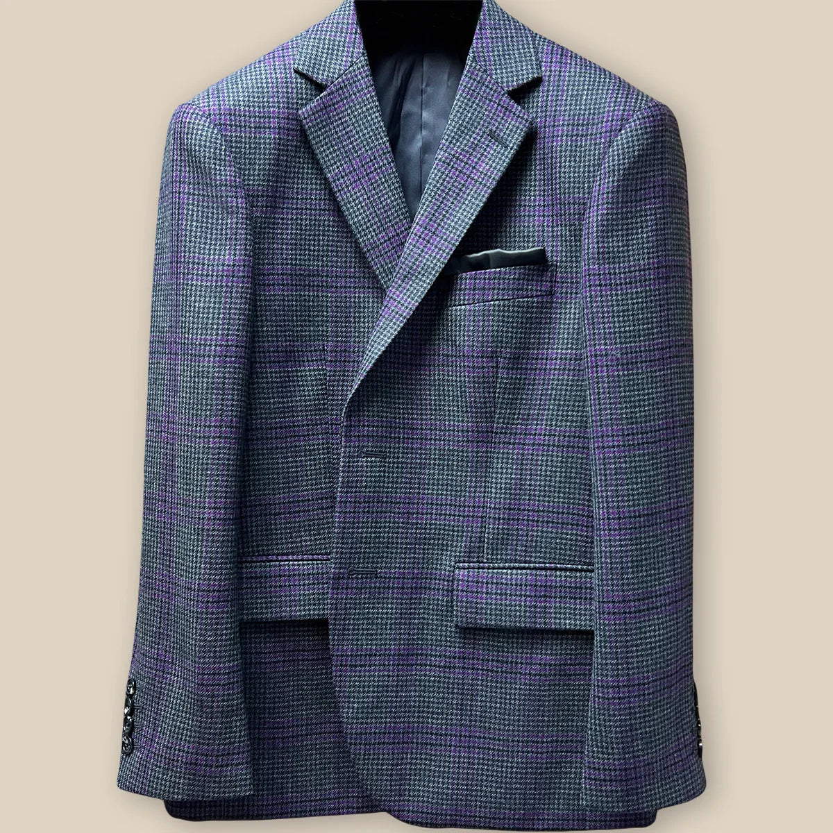 Close-up of grey and purple plaid fabric with buttonhole detail on custom Westwood Hart sport coat