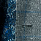 Detailed view of the buttonhole stitching on the Westwood Hart grey with medium blue windowpane men's sport coat.