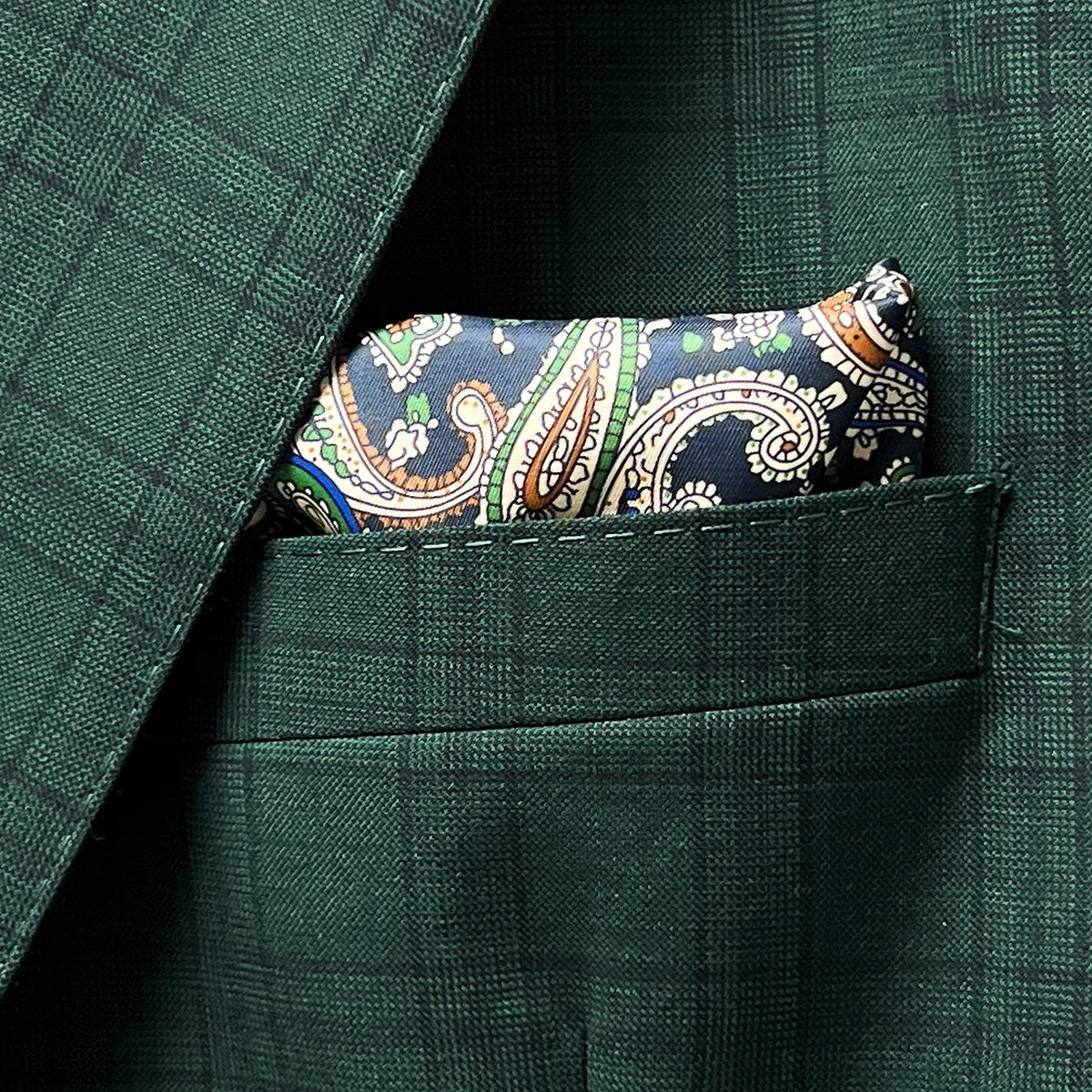 Breast pocket of hunter green checkered sport coat jacket with built-in pocket square holder and hand-finished edges