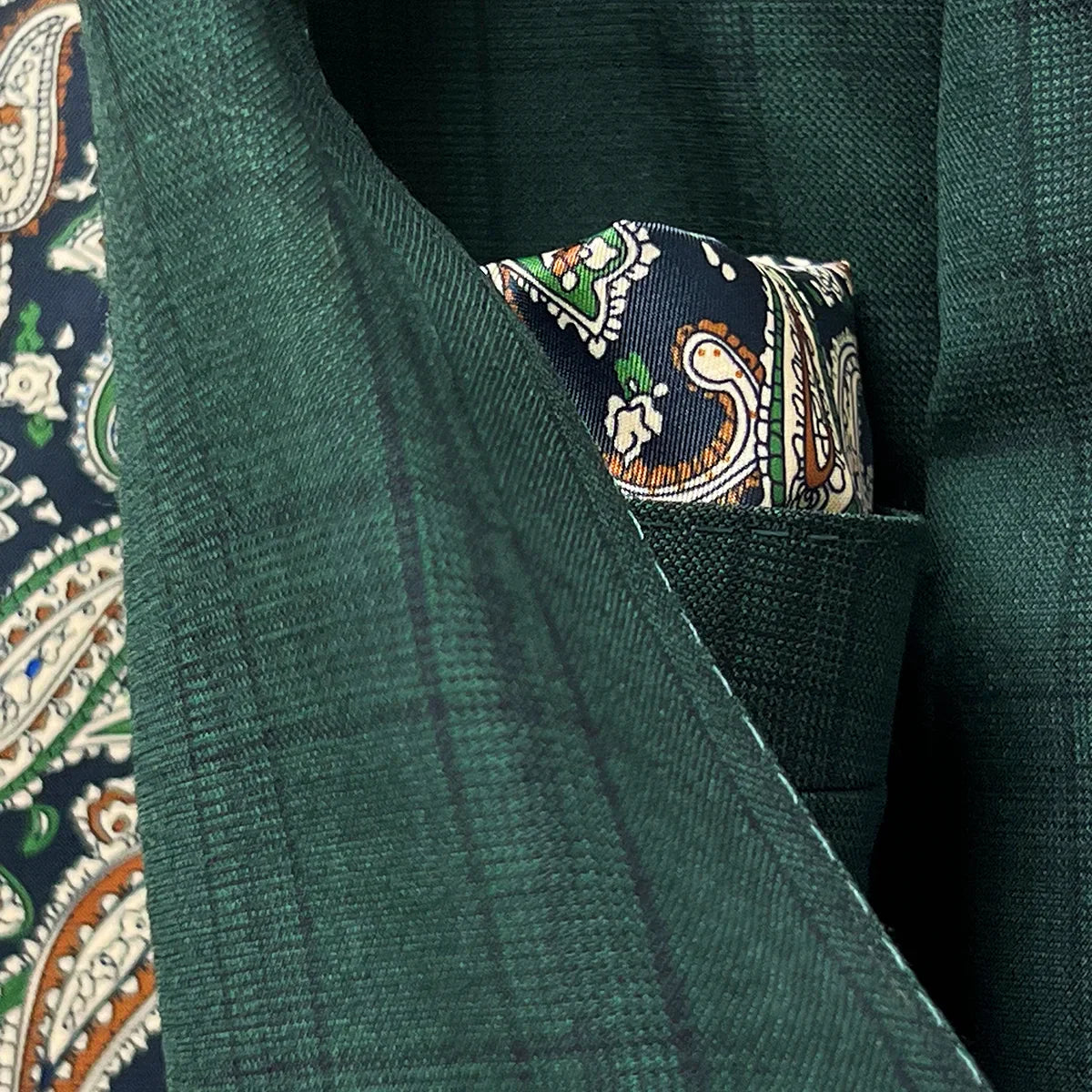 Detailed close-up of Super 120's wool fabric texture showing hunter green base with sophisticated black checkered pattern