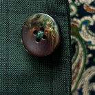 Close-up of walnut brown with green horn buttons showing natural marble-like patterns and rich coloring