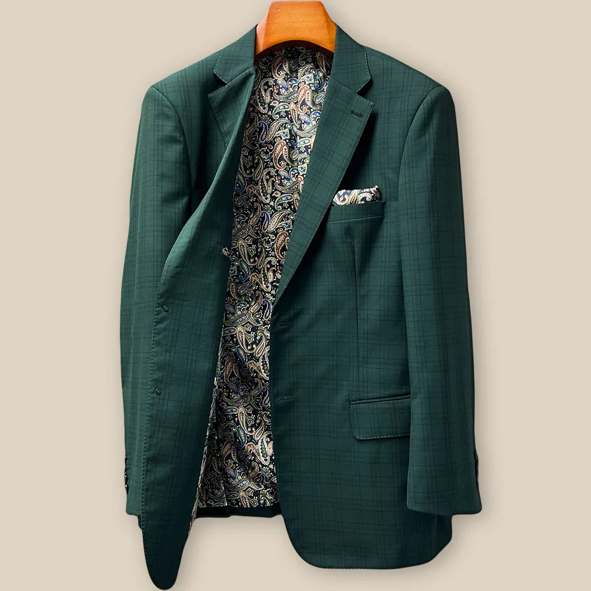 Interior right side of hunter green checkered sport coat jacket revealing paisley lining and internal construction details