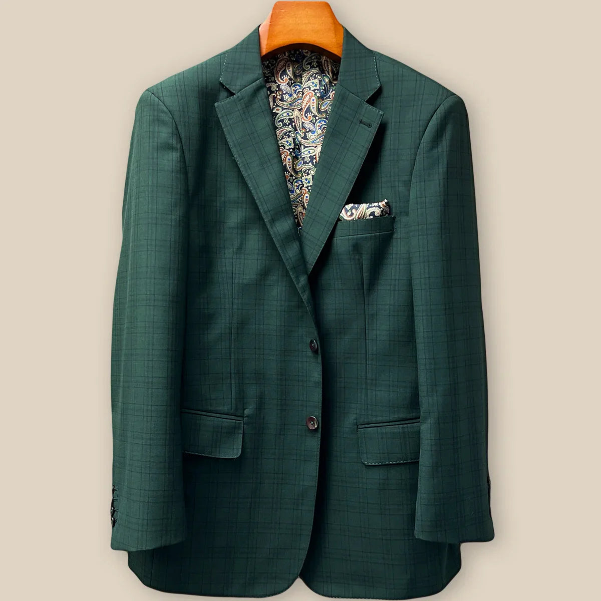 Front button panel of hunter green checkered sport coat jacket featuring walnut brown with green horn buttons and hand pick stitching