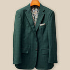 Front button panel of hunter green checkered sport coat jacket featuring walnut brown with green horn buttons and hand pick stitching