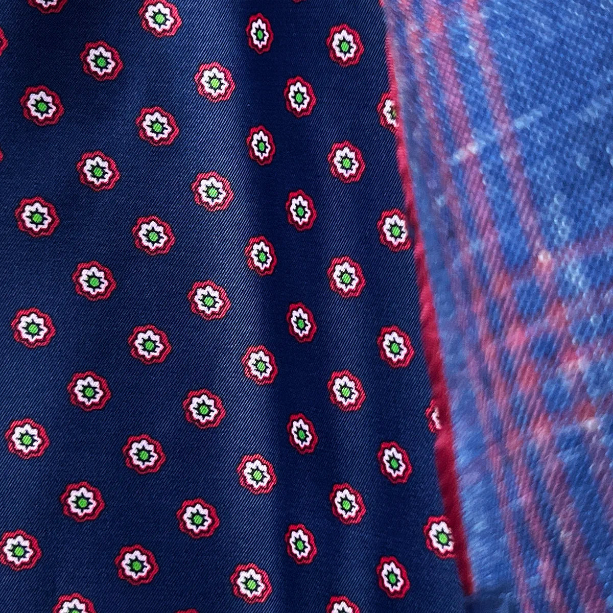 Detailed view of hand-executed pick stitching along lapel edges, showcasing the meticulous craftsmanship in dark berry maroon thread