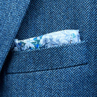 Breast pocket of indigo blue herringbone tweed sport coat with built-in floral skull pocket square and hand-finished edges