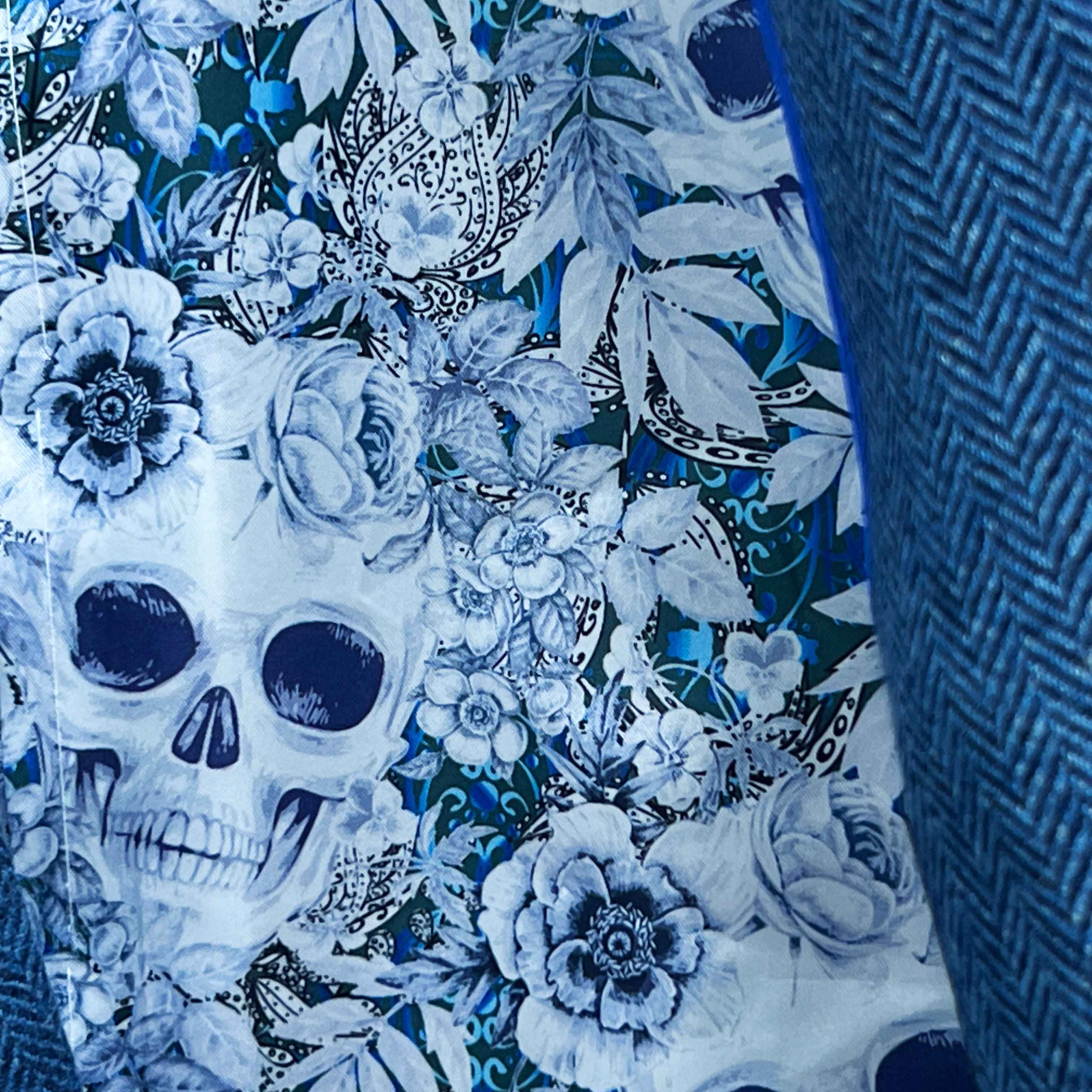 Colorful flash lining detail visible at jacket cuffs and vents in blue and white floral skull pattern