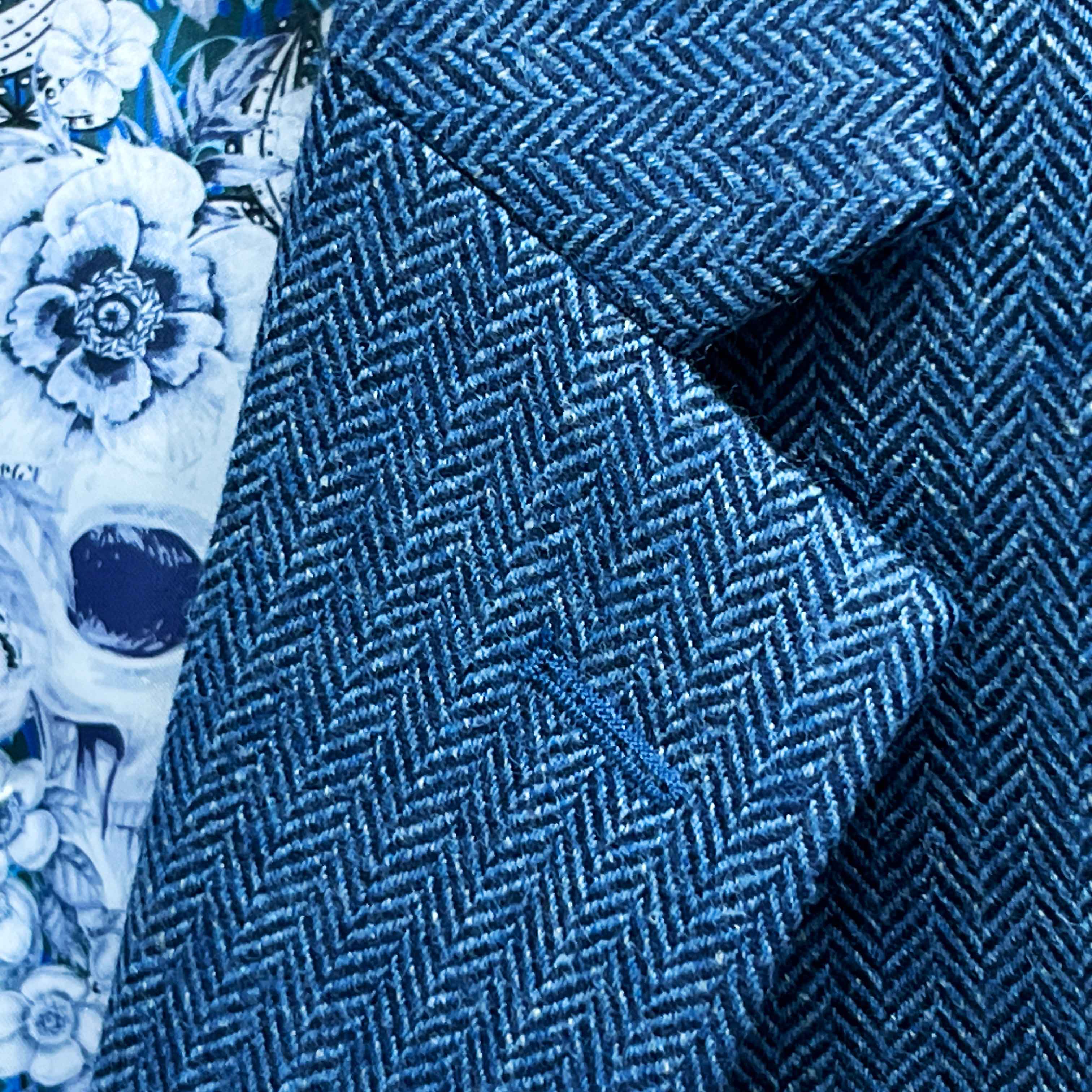 Classic notch lapel detail on indigo blue herringbone tweed sport coat showing hand pick stitching and herringbone pattern
