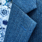 Classic notch lapel detail on indigo blue herringbone tweed sport coat showing hand pick stitching and herringbone pattern