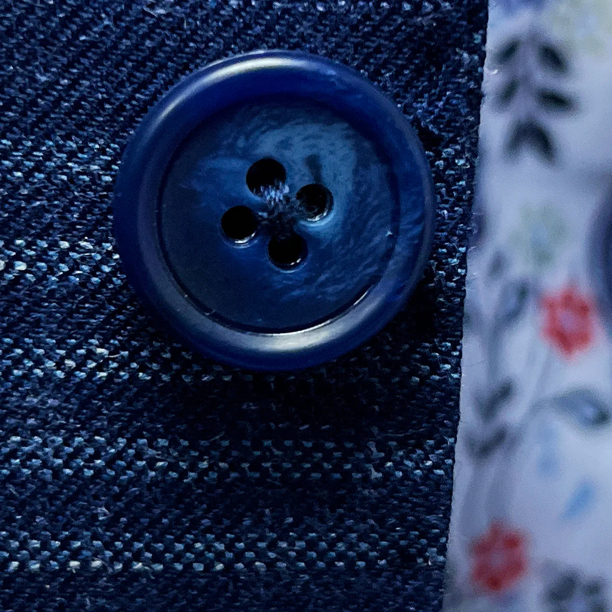 Close-up of navy horn marble buttons showing natural texture variations and premium quality hardware selection