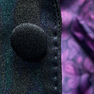 Macro detail of iridescent teal green purple black tuxedo fabric showing abstract pattern and colour-shifting properties under lighting