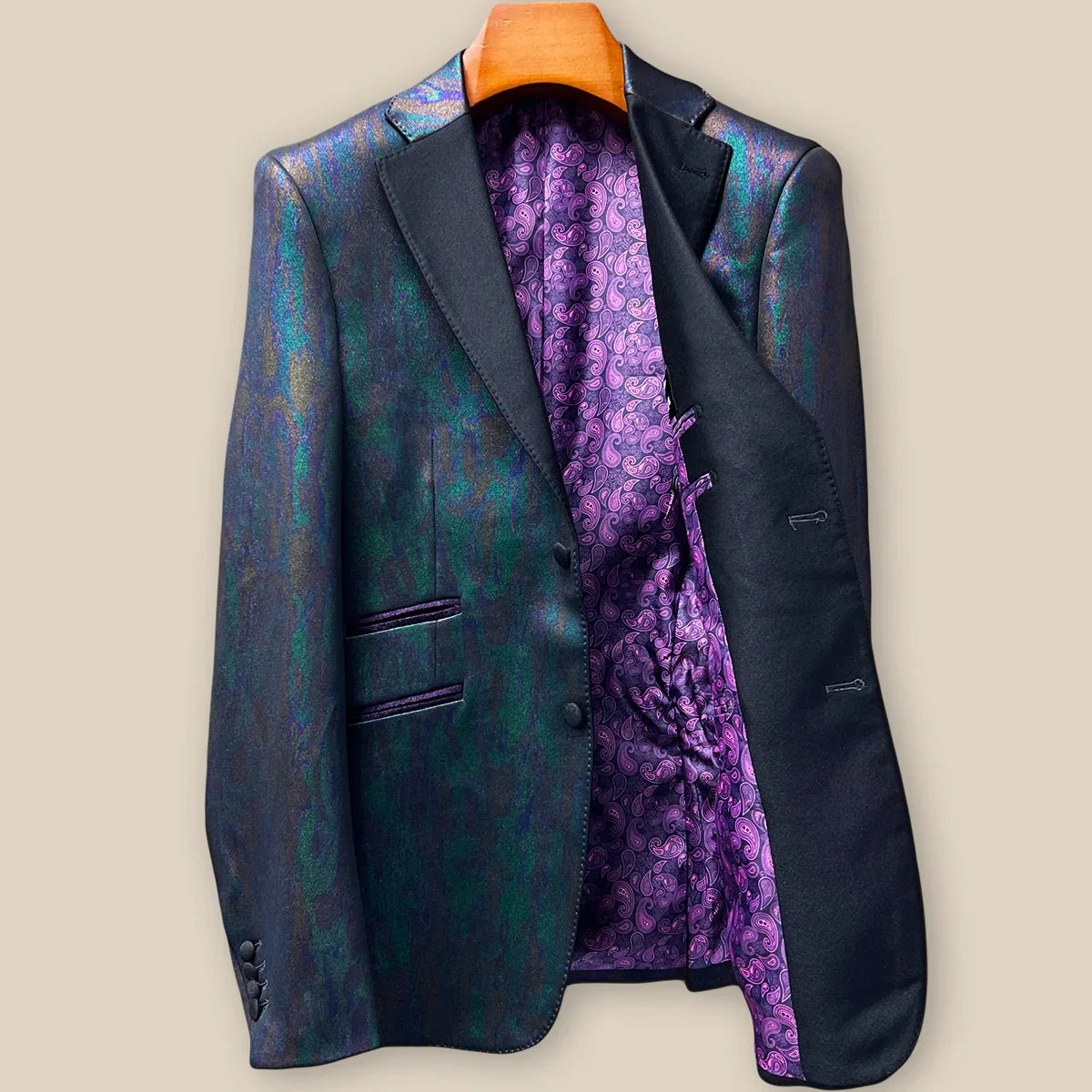 Interior left side of iridescent teal green purple black tuxedo jacket displaying luxurious purple paisley lining with inner pocket