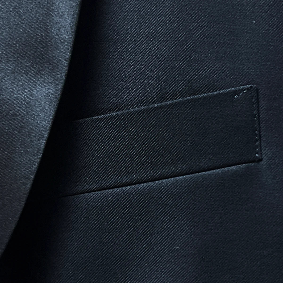 Detail of boutonnière buttonhole on silk satin-faced shawl lapel