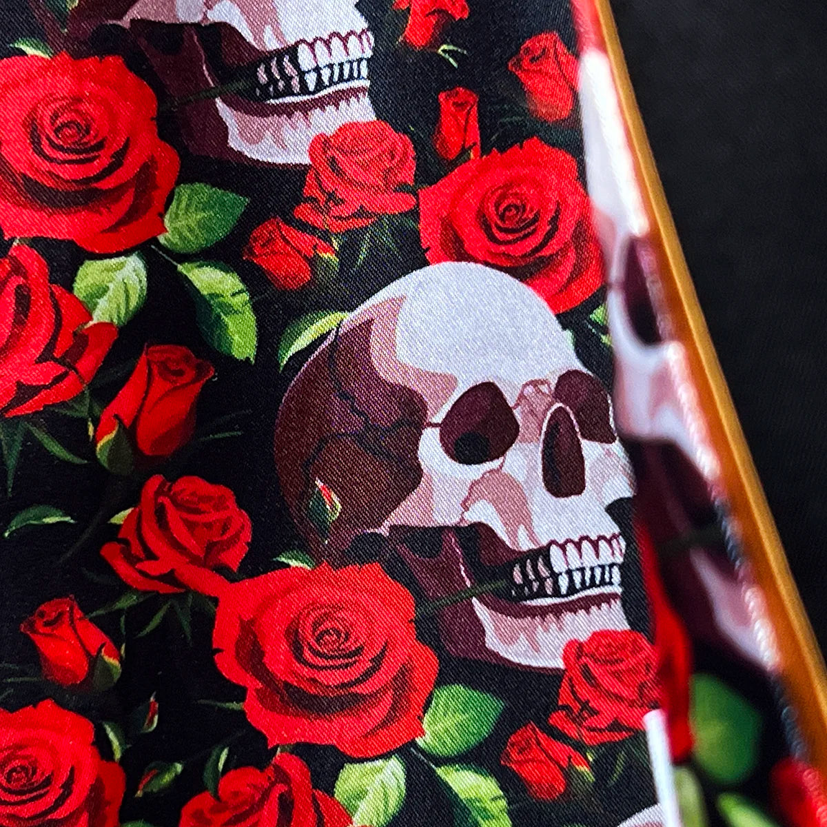 Detail of dramatic skull and rose pattern flash lining showing intricate print design