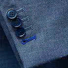 Detail of suit jacket sleeve showing functional buttonholes with navy horn marble buttons