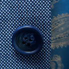 Detailed view of navy horn marble buttons used on the light blue birdseye suit