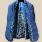 Full interior view of light blue suit jacket showcasing vibrant blue and gold paisley flash lining