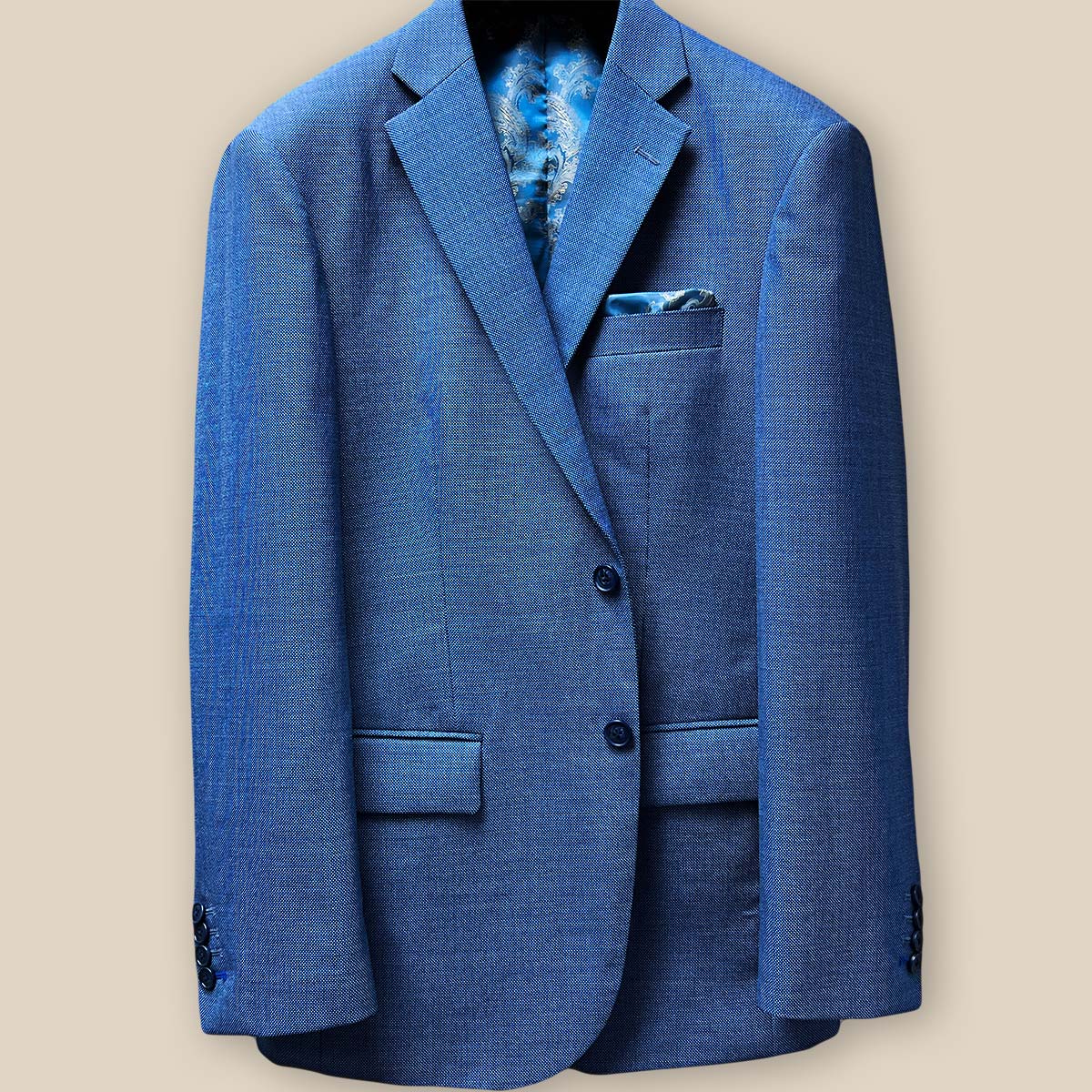 Close-up of light blue suit jacket front, showcasing navy horn marble buttons and buttonholes