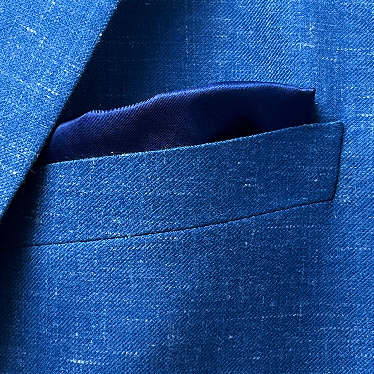 Detail of breast pocket on light blue Westwood Hart suit jacket, featuring a built-in pocket square option