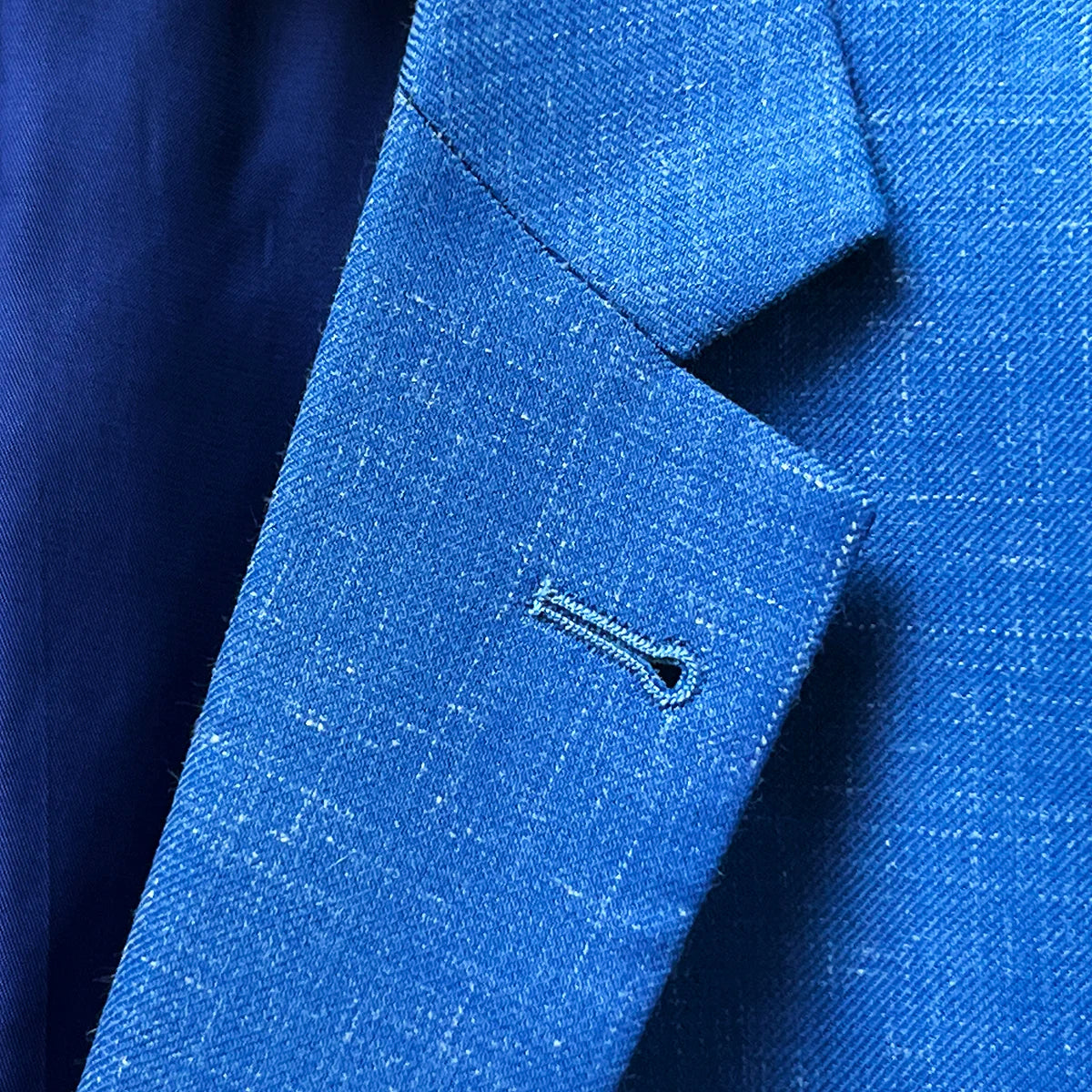 Close-up of notch lapel on light blue Westwood Hart suit jacket, showcasing classic styling