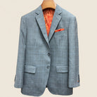 Front button panel of light gray with light blue windowpane sport coat featuring dark gray horn buttons and hand pick stitching