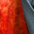 Colorful flash lining detail visible at jacket cuffs and vents in bright orange paisley jacquard pattern