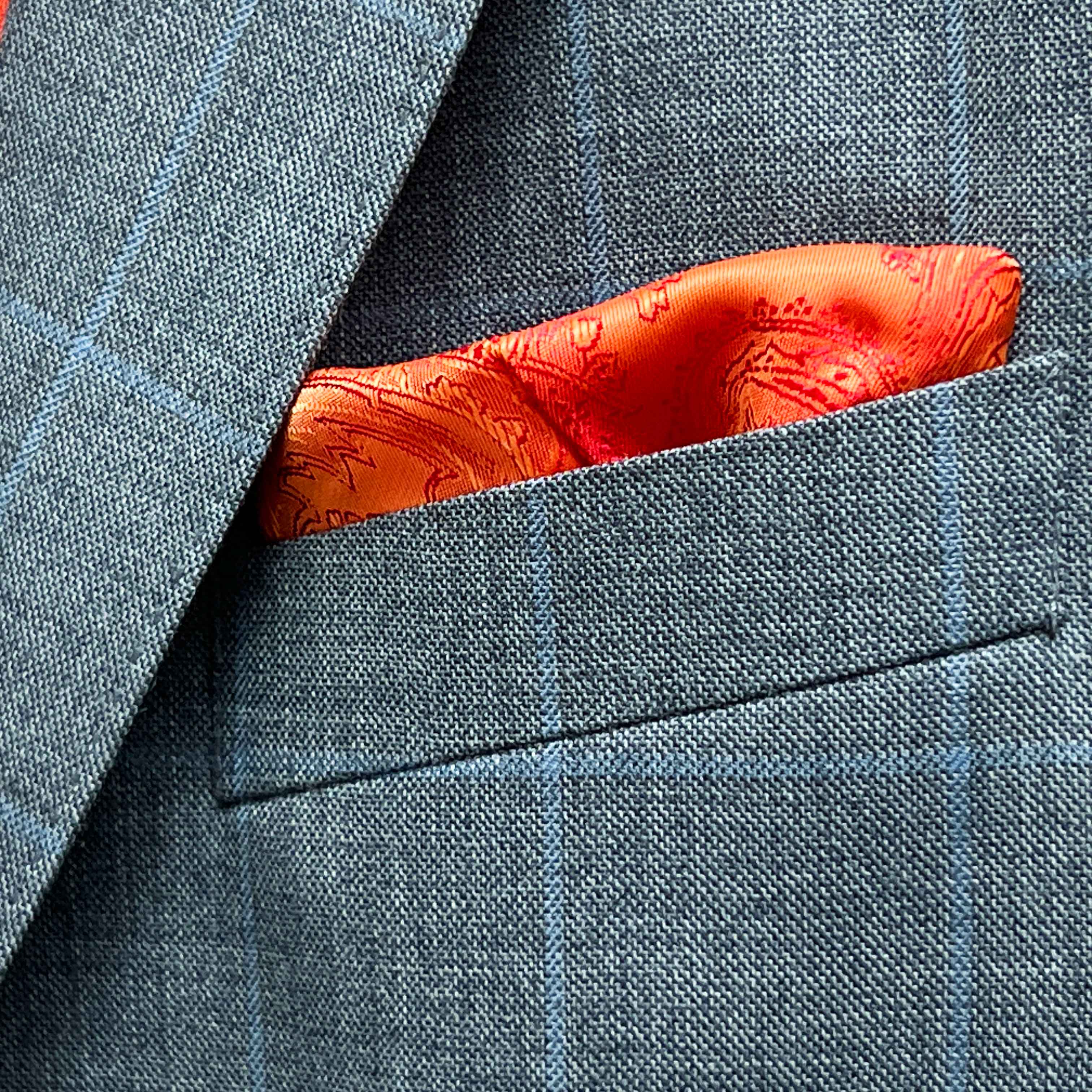 Breast pocket of light gray with light blue windowpane sport coat with built-in pocket square holder and hand-finished edges